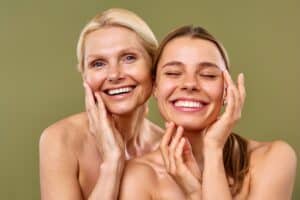 A younger woman and an older woman, both with healthy glowing skin