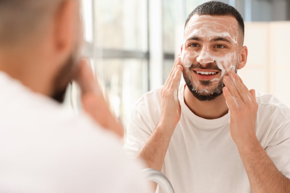 Man washing his face during a skincare routine
